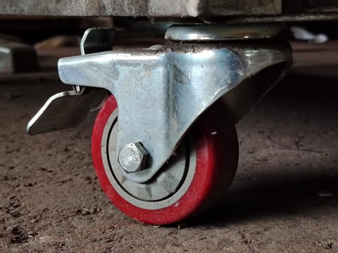 Heavy duty swivel caster wheel with red polyurethane tread and lock mechanism for industrial equipment